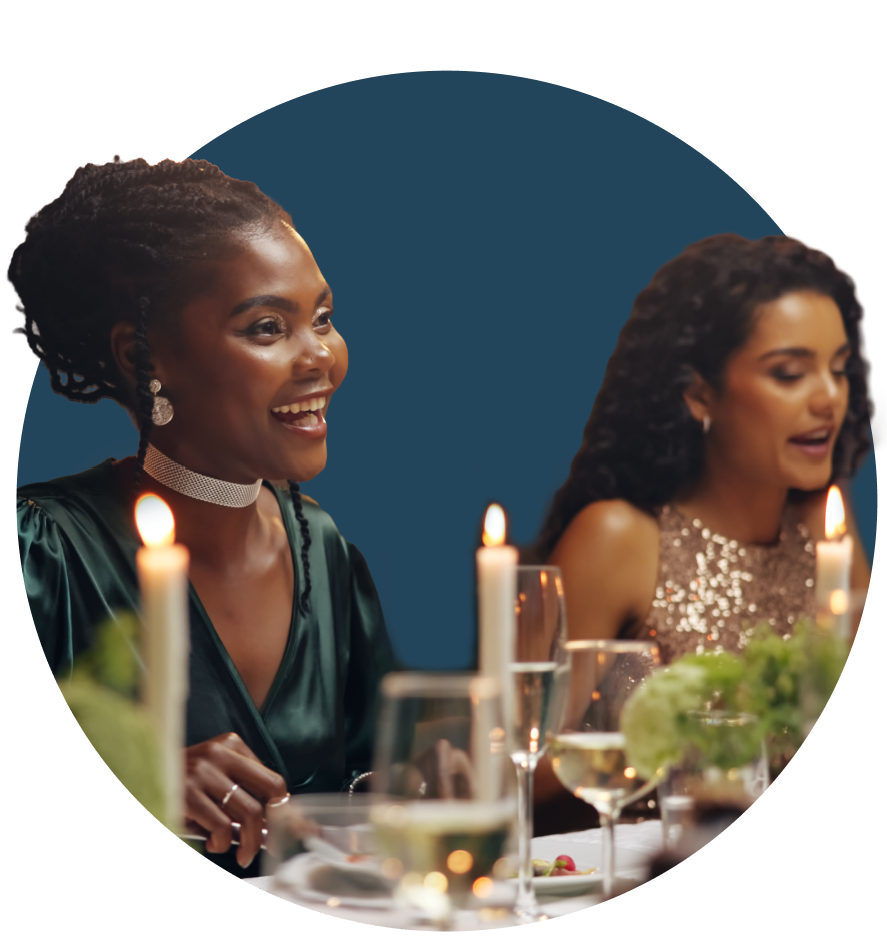 women in formal attire at dinner table